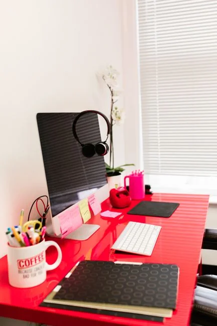 Dual monitors on a desk, showcasing web design in a modern office setting.